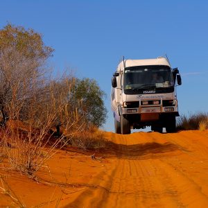 4WD bus crossing the red sand ridges of Strzelecki Desert on Corner Country Outback Tour