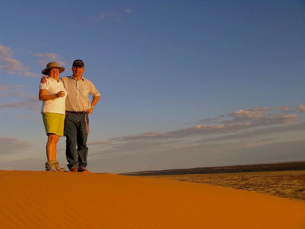 Adventure travel at is best, greeting the sunset on top of 'Big Red' in Nature Bound Australia's Corner Country Outback Tour