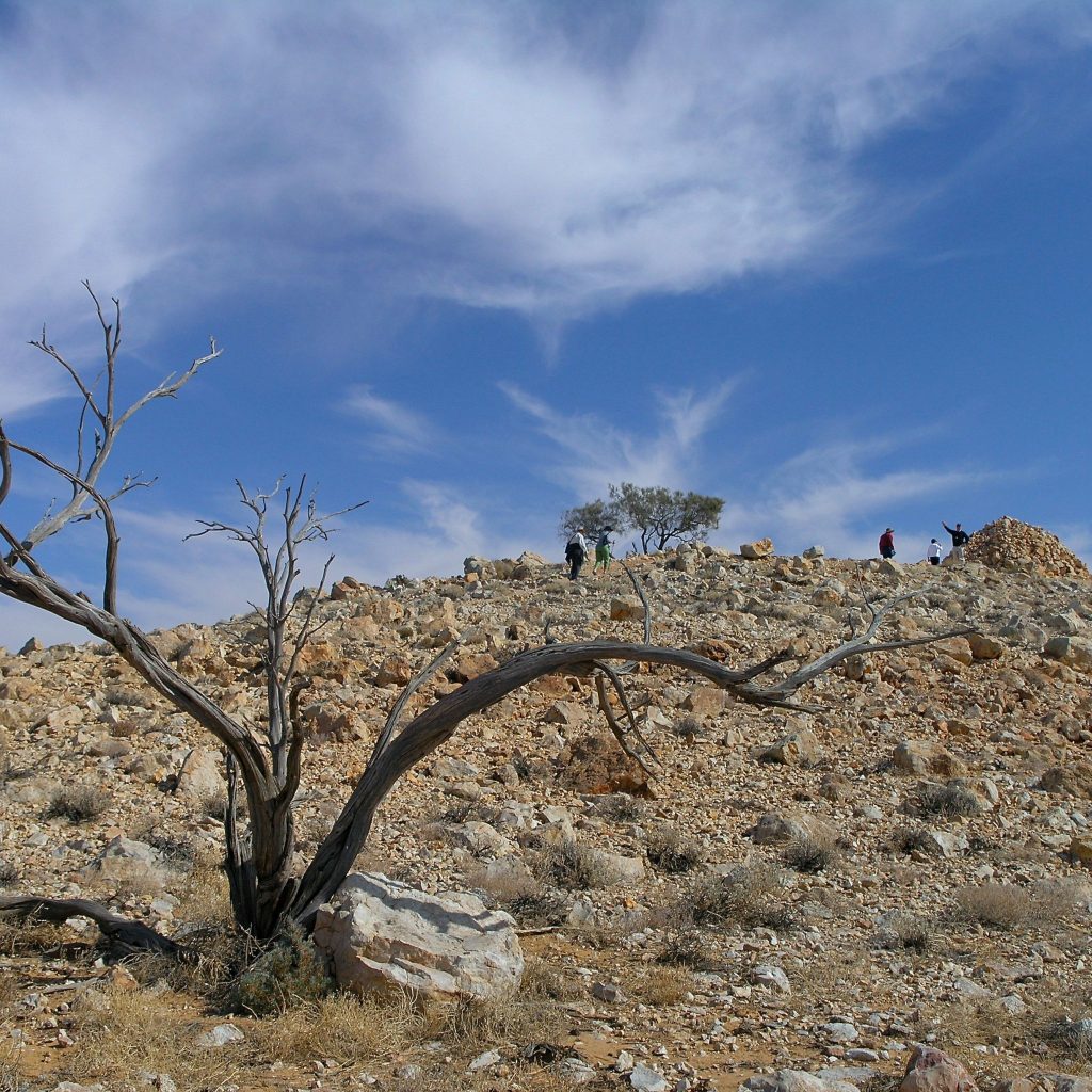 Stony hill and memorial cairn in the desert, visited on the Corner Country Outback Tour